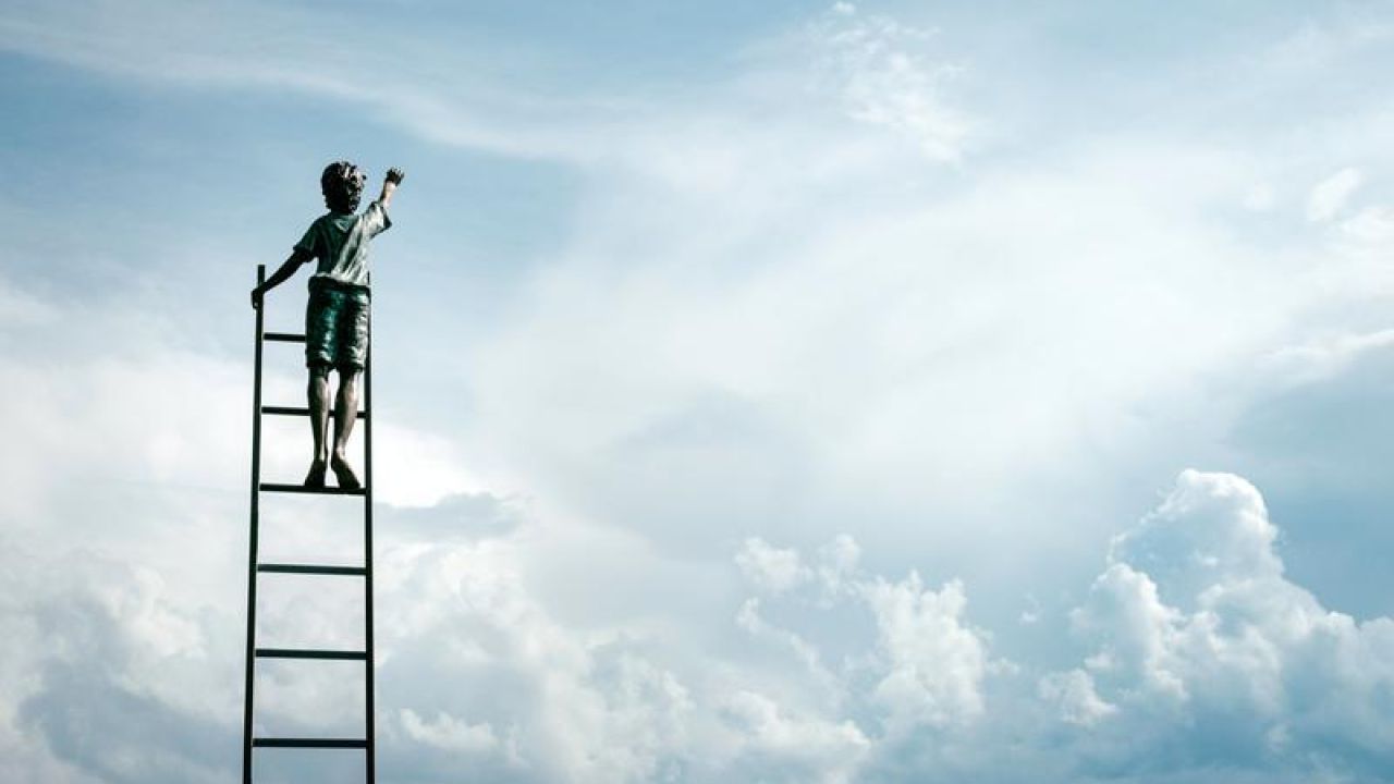 kid reaching out to the sky