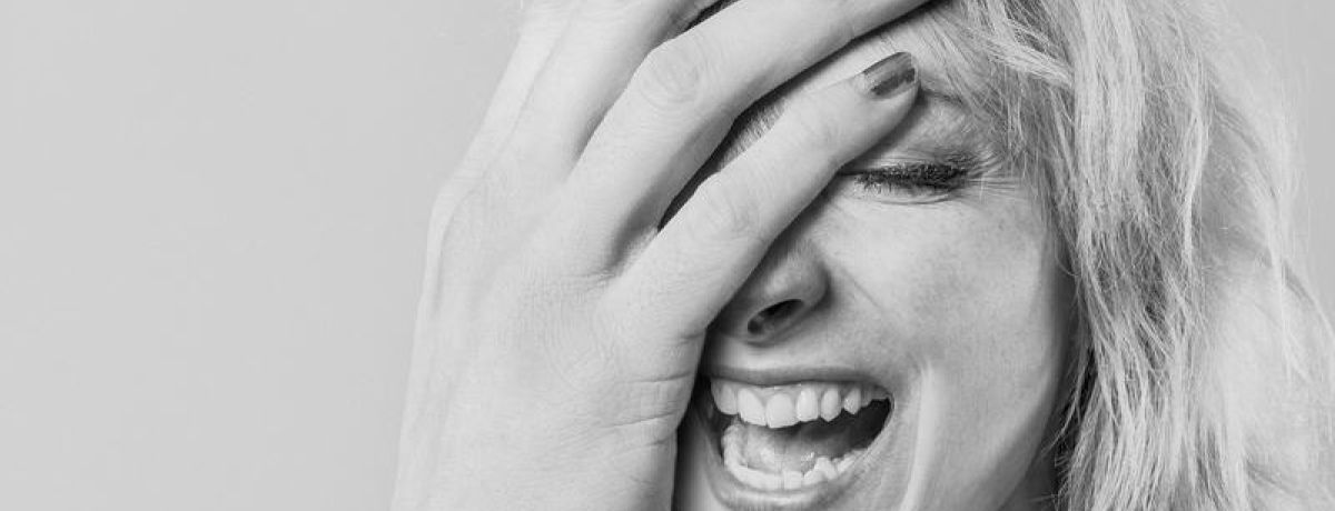Woman With Absurdly Large Hand Laughing