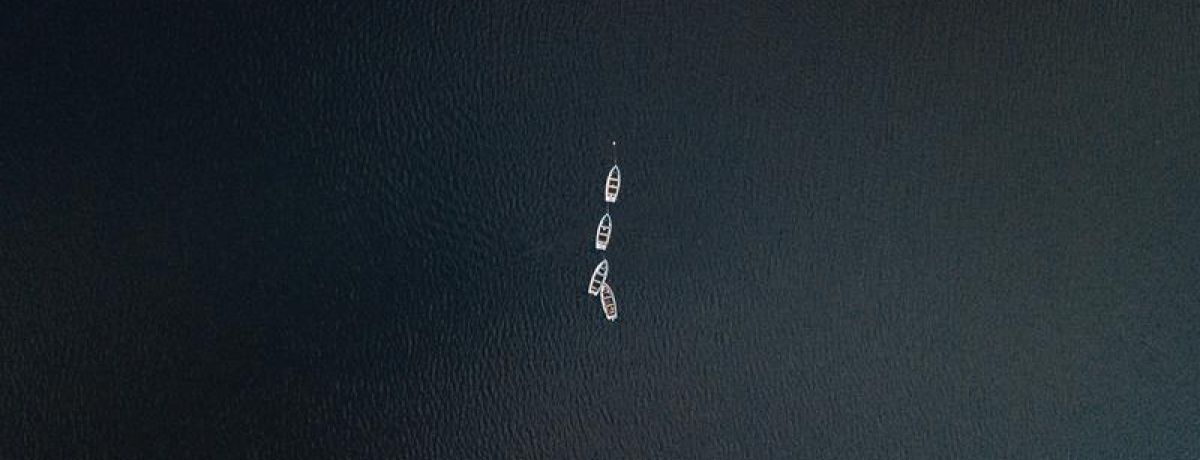 boats in the middle of a large ocean