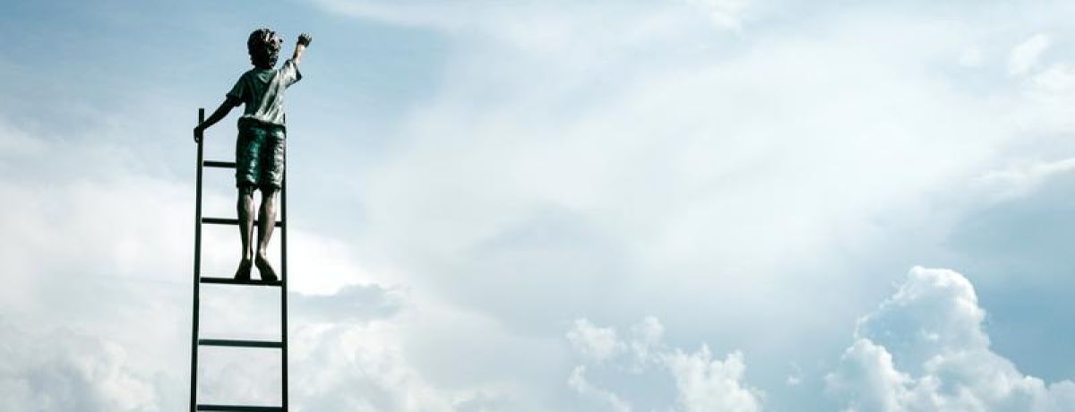 kid reaching out to the sky