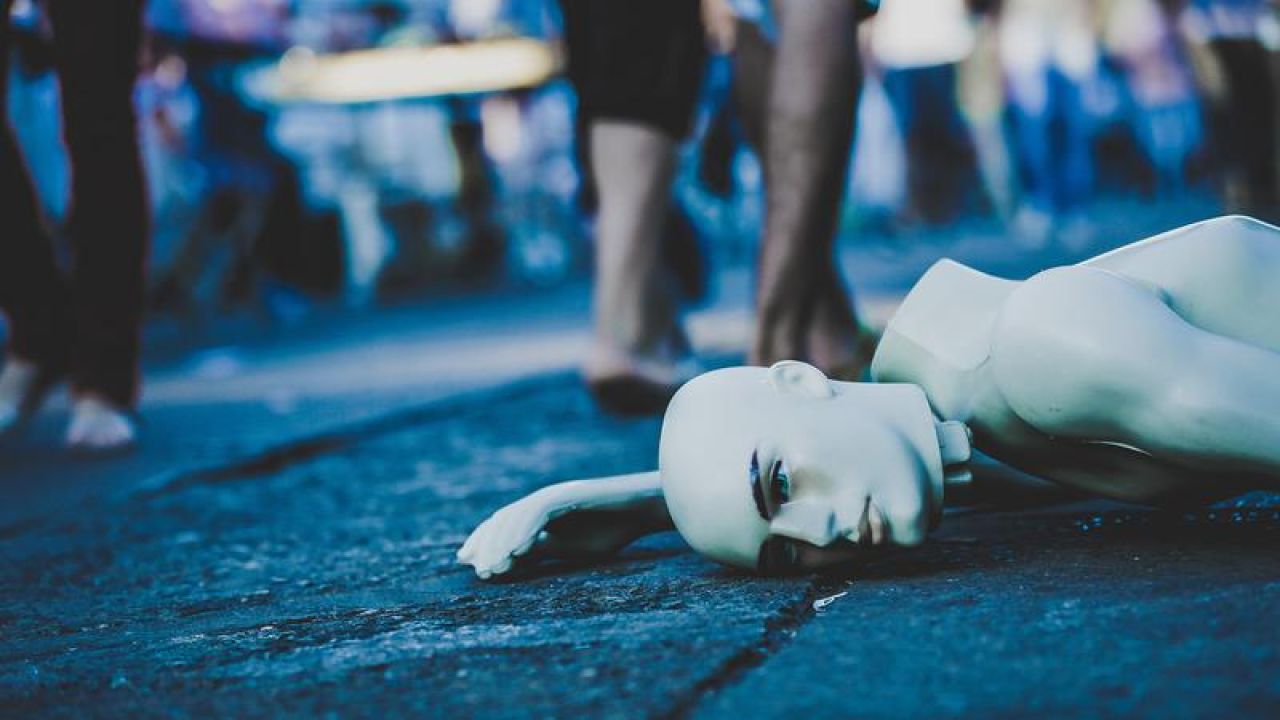 A broken mannequin laying on the street in Taguatinga
