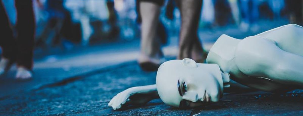A broken mannequin laying on the street in Taguatinga