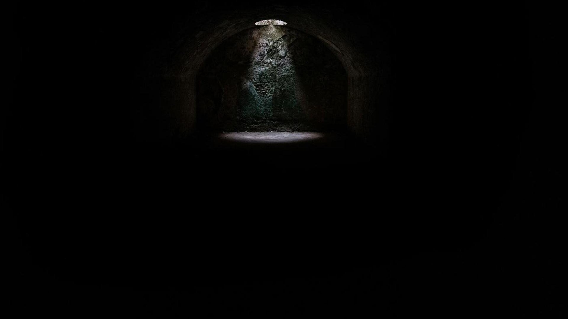 a dark dungeon with a light shining