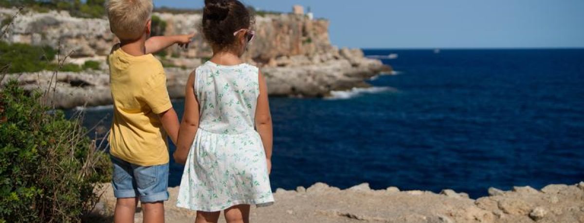 boy leading a girl, pointing out to the horizon