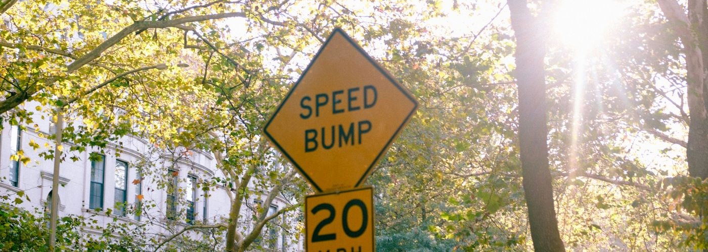 speed bump sign, neighborhood, outdoors