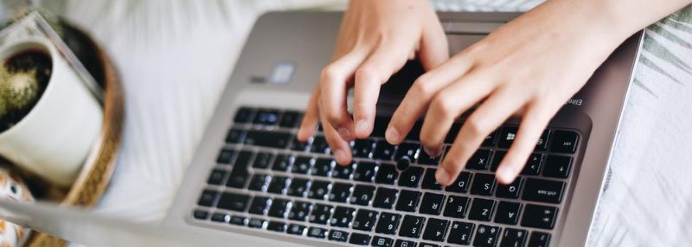 typing on a computer on a table