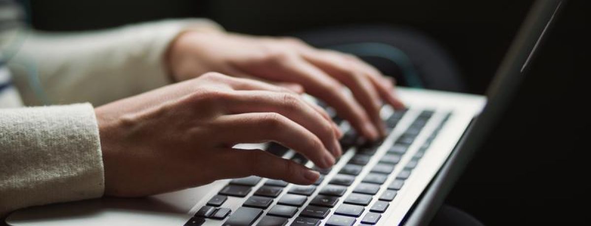 hands typing on a computer