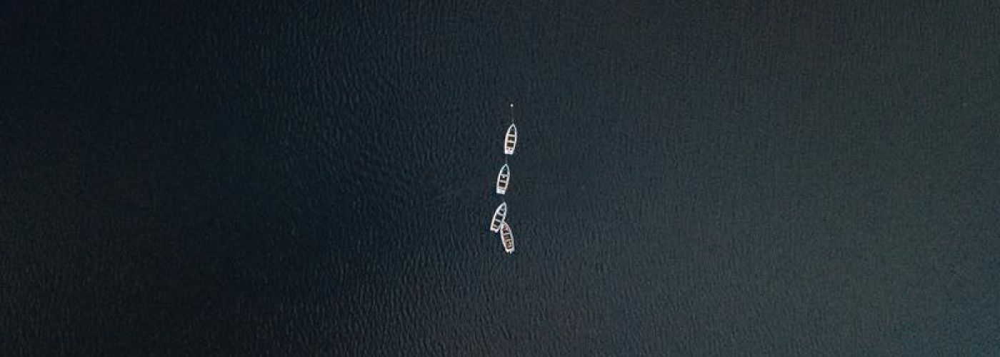 boats in the middle of a large ocean