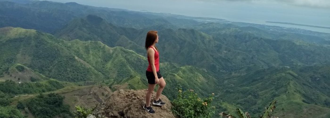 Woman standing on mountain looking out