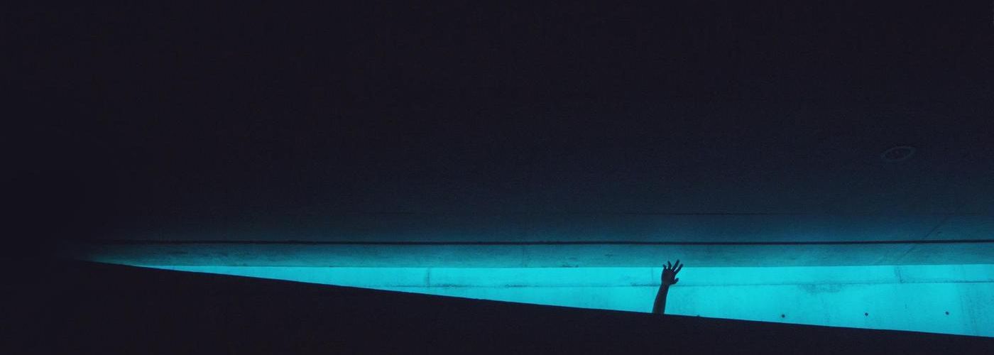 nightime, poolside, hand in the air