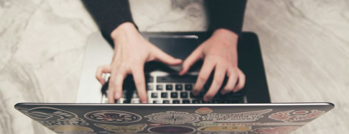 woman typing on a computer on a desk indoors