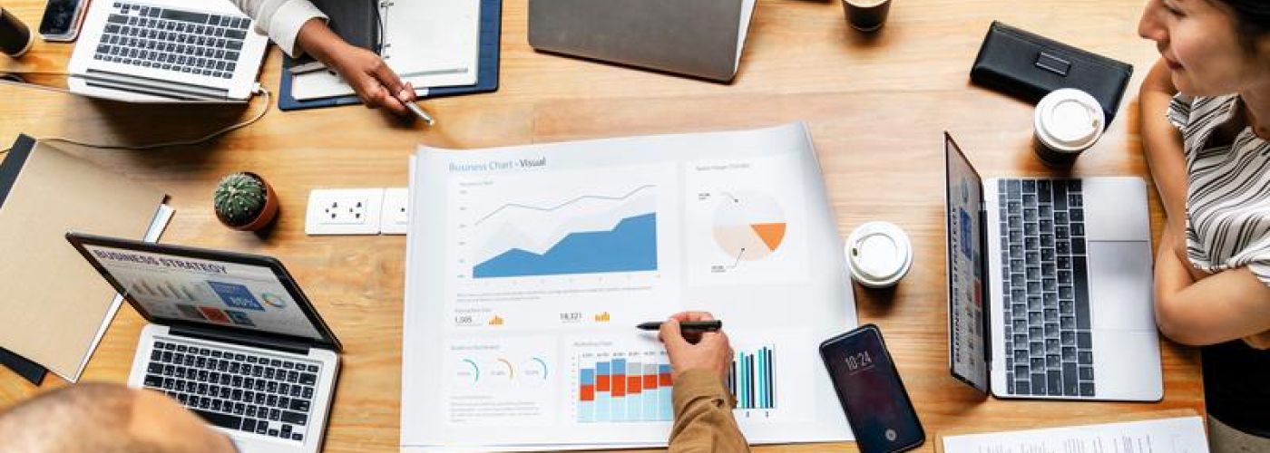 Business report gathering around table to review