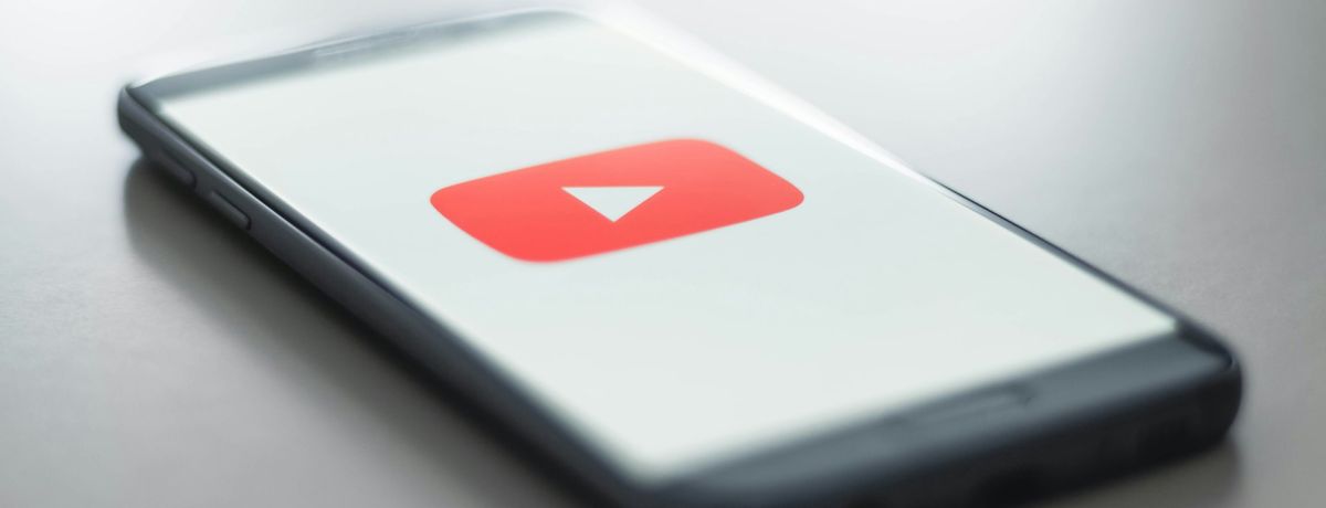 youtube, mobile phone, on table, indoors