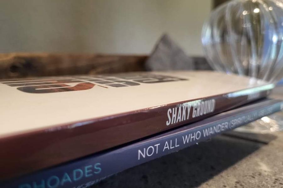 Traci Rhoades, Shaky Ground book stack, indoors