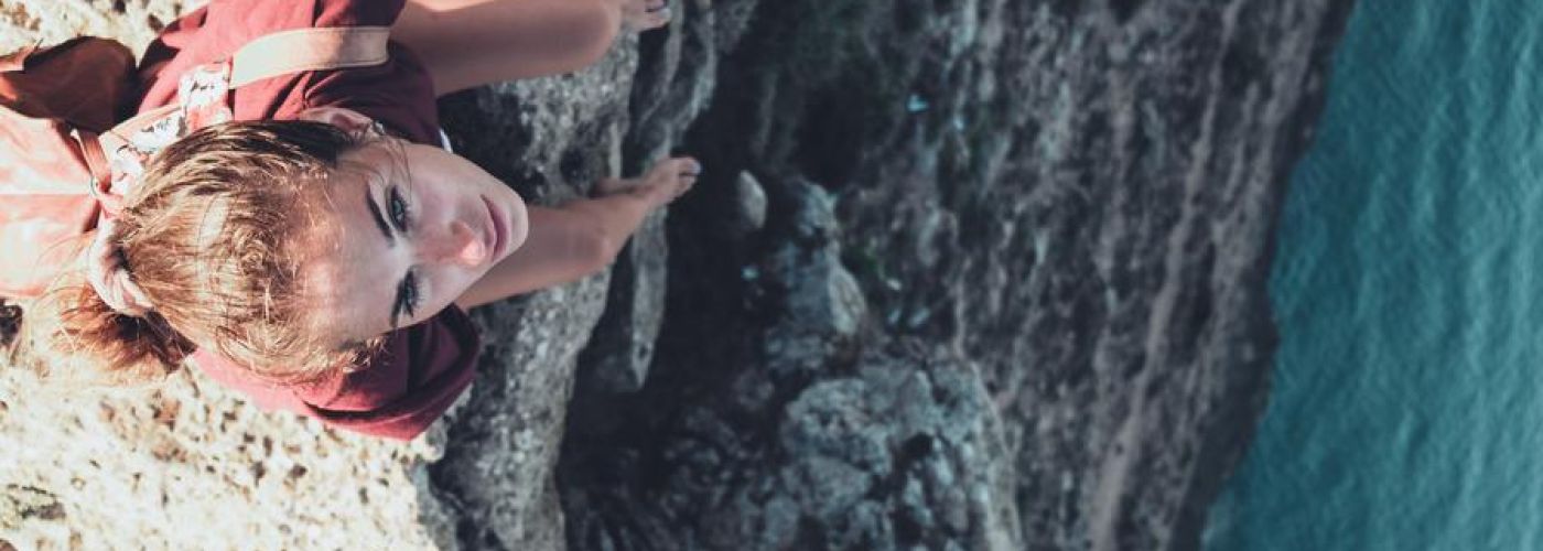 Girl Sitting On The Edge Of A Cliff Water