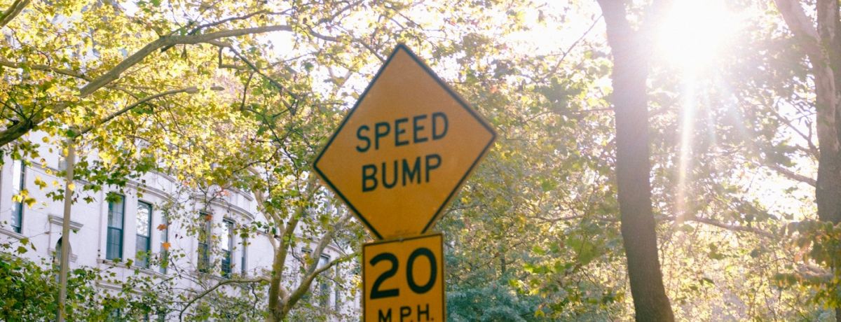 speed bump sign, neighborhood, outdoors