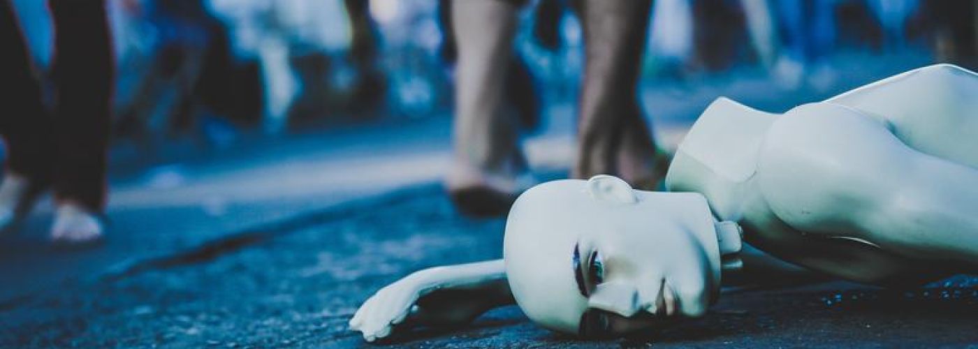 A broken mannequin laying on the street in Taguatinga