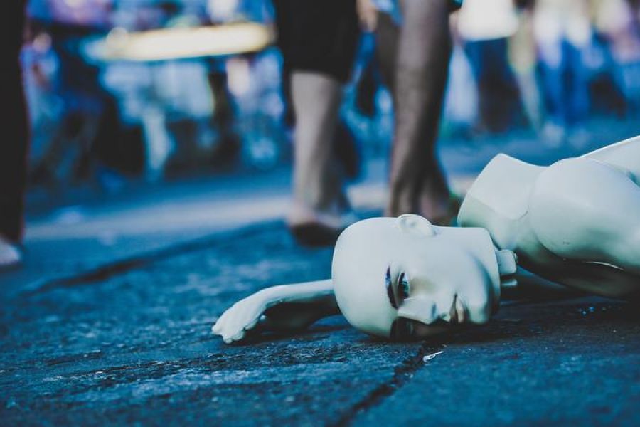 A broken mannequin laying on the street in Taguatinga