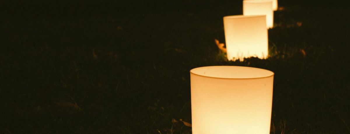 string of candles on the ground at night