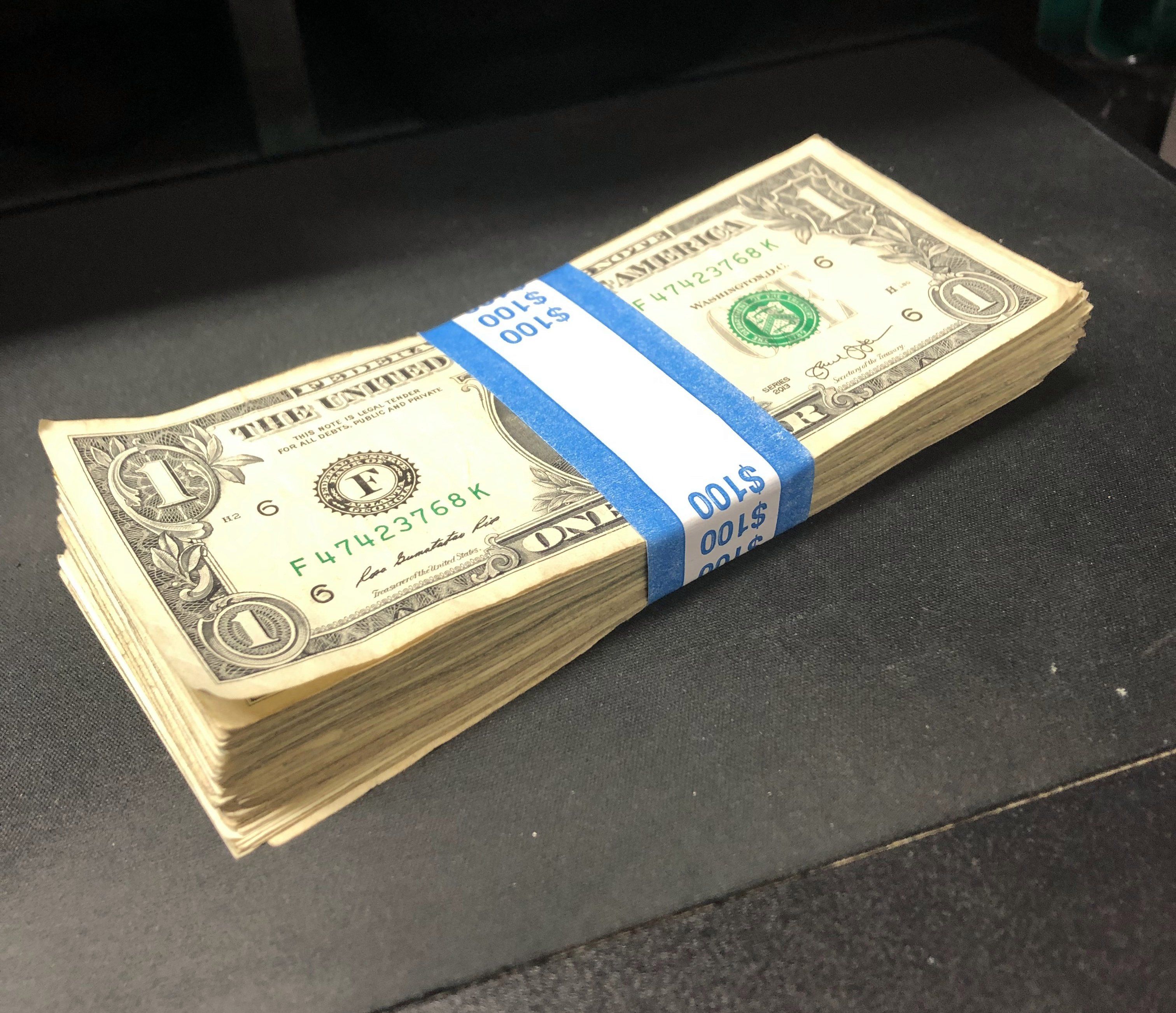 a stack of a hundred one dollar bills