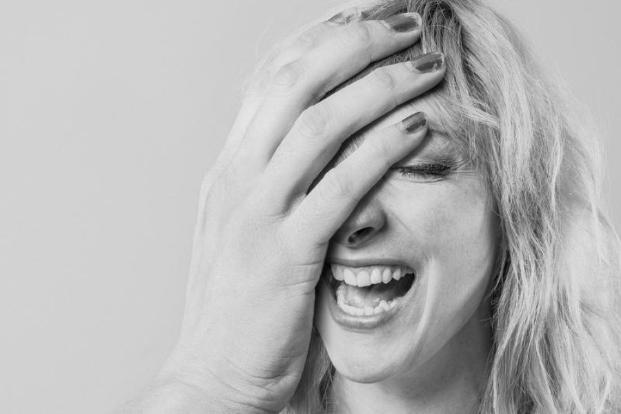 Woman With Absurdly Large Hand Laughing