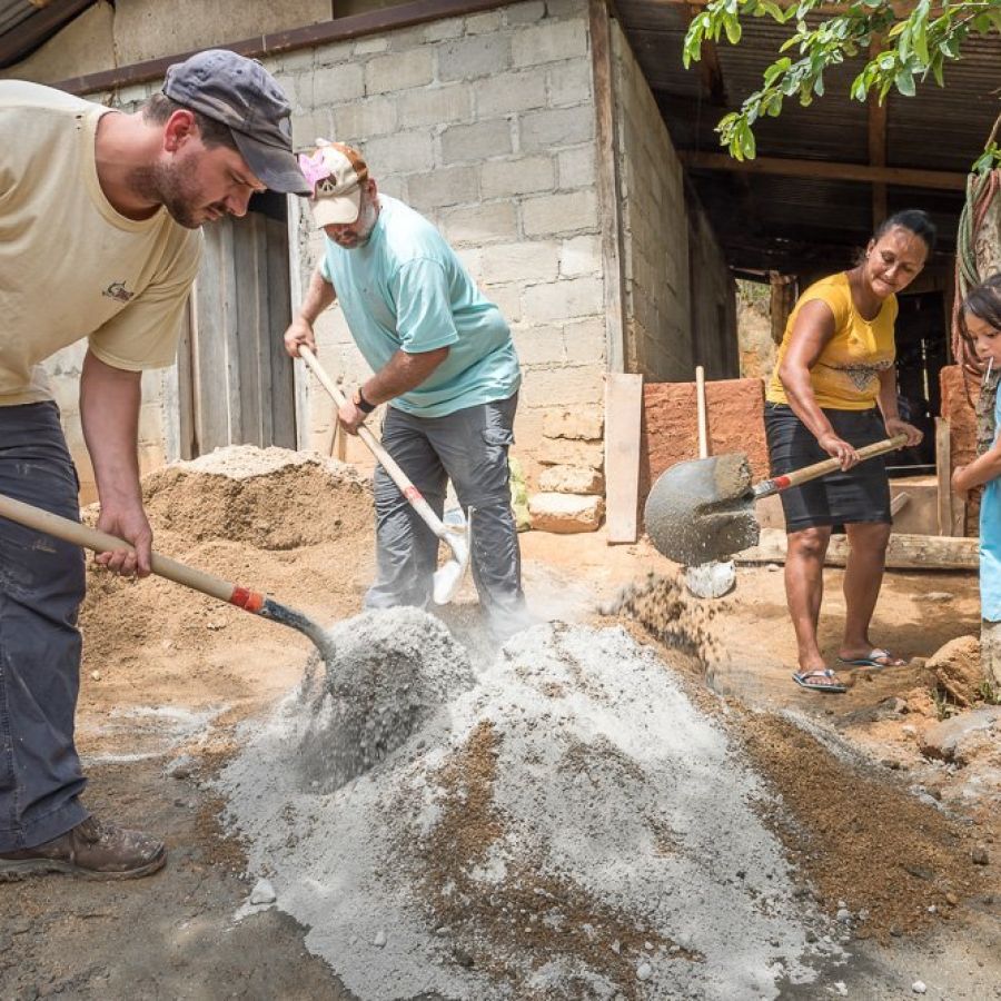 men making a pile of cement