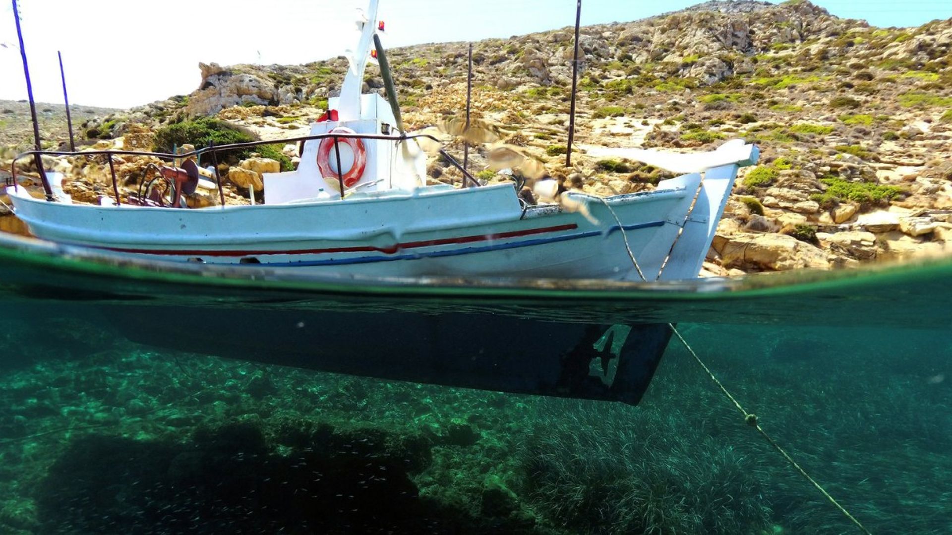a boat waterline, underwater and above water, by land