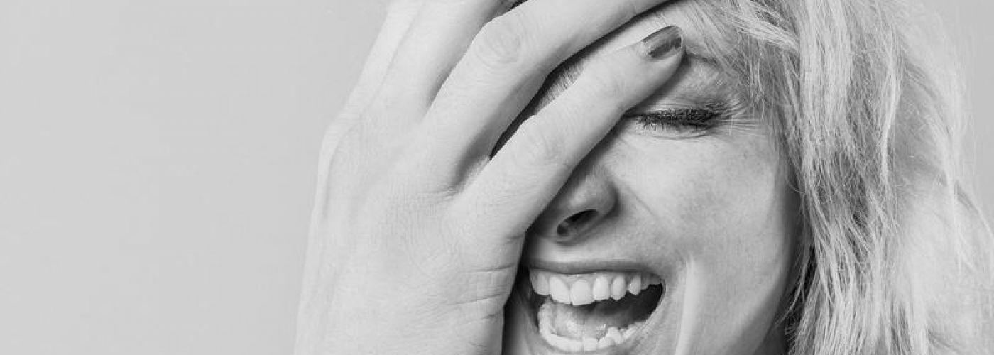 Woman With Absurdly Large Hand Laughing