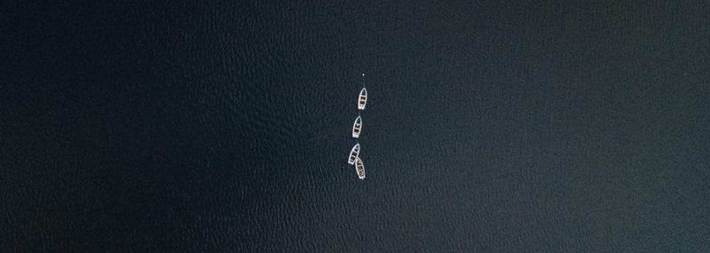 boats in the middle of a large ocean
