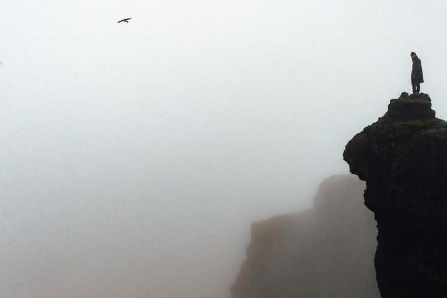 looking out to the horizon over a foggy cliff